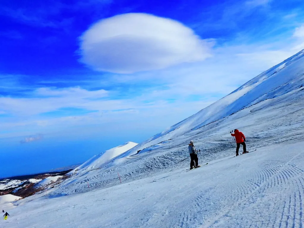 people skiing on Etna, Sicily, during Winter